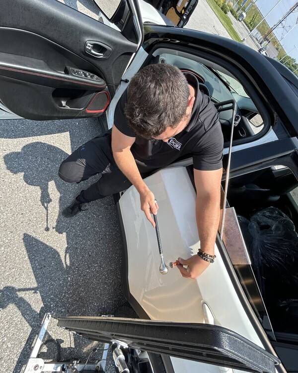 Tyler DeCarlo fixing a dent on a bodyline